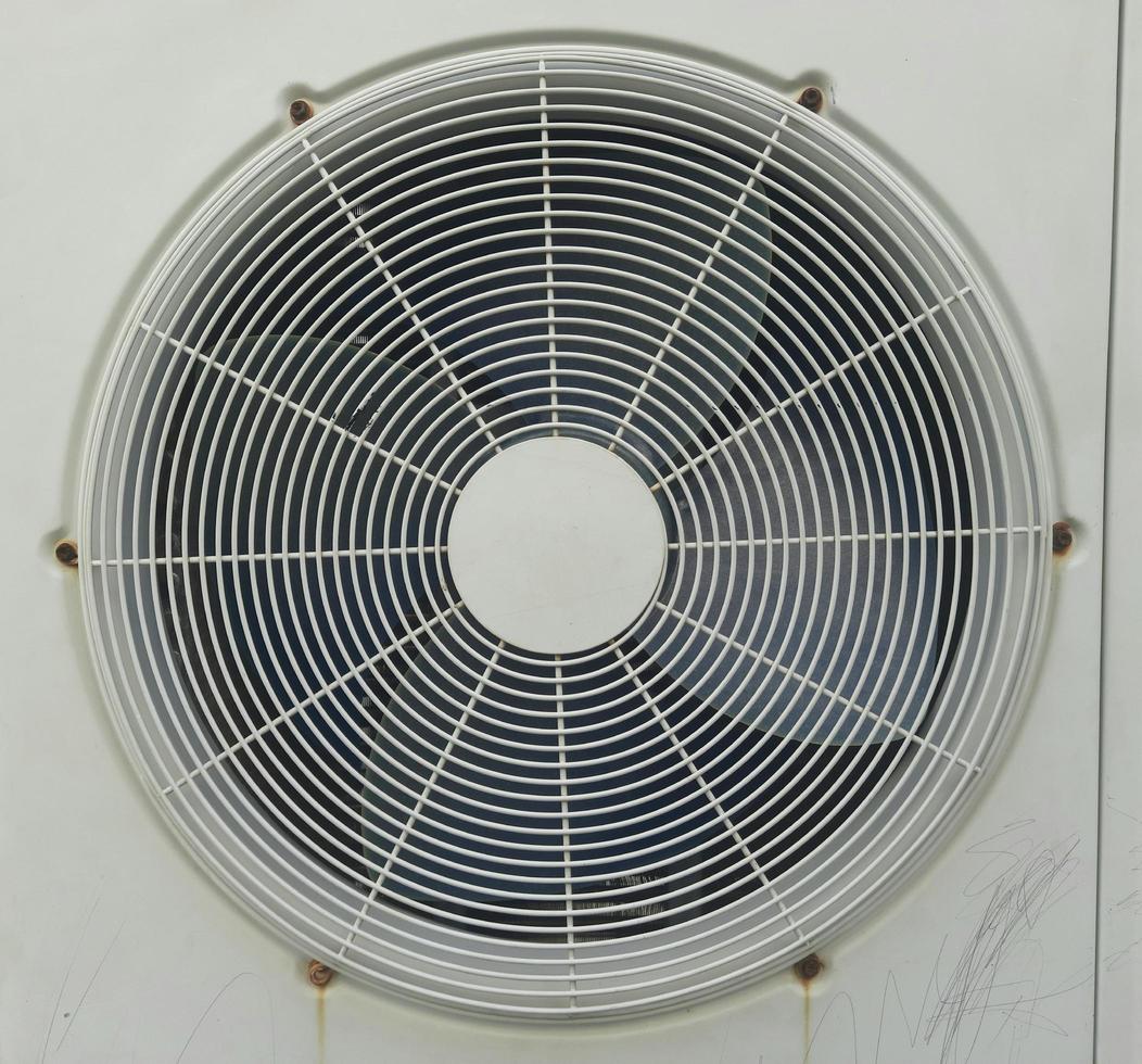 An old outdoor AC fan with white color and good lighting photo