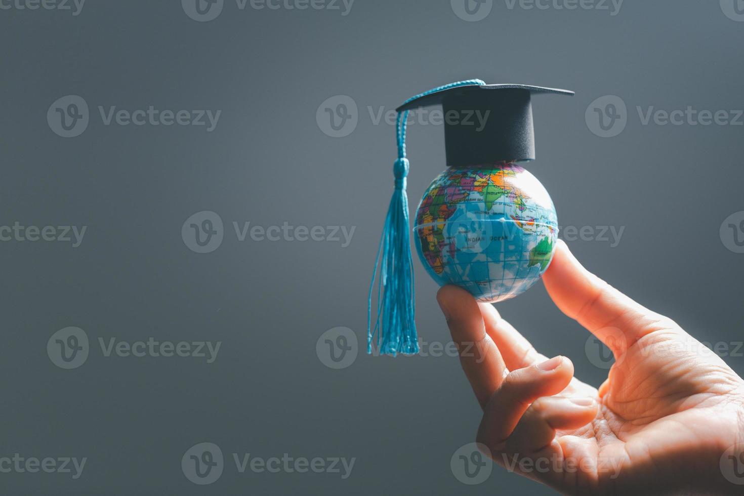 Graduation cap with Earth globe. Concept of global business study, abroad educational, Back to School. Education in Global world, Study abroad business in universities in worldwide. language study photo