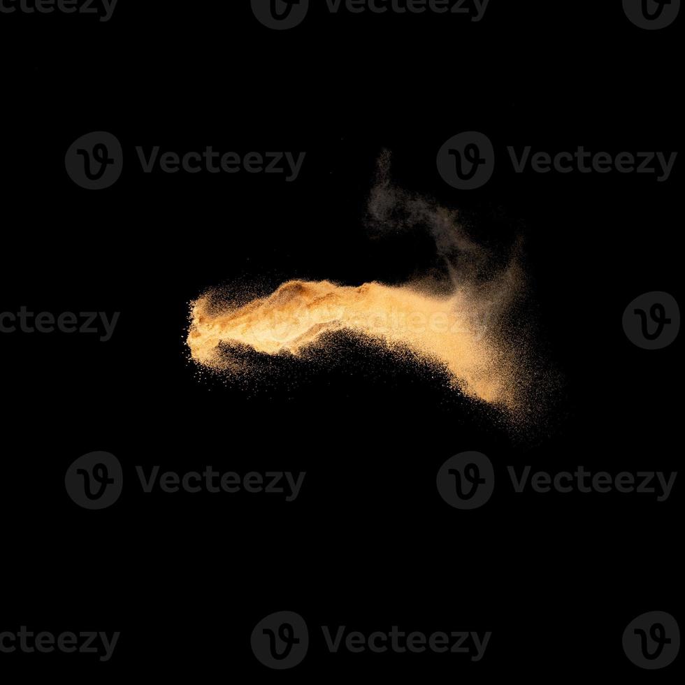 Sand explosion isolated on black background. Freeze motion of sandy dust splash.Sand texture concept. photo