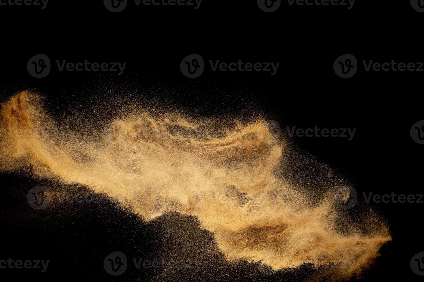 Dry river sand explosion.Brown color sand splash against black background. photo