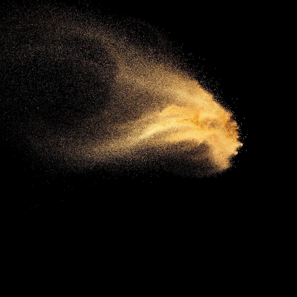 Sand explosion isolated on black background. Freeze motion of sandy dust splash.Sand texture concept. photo