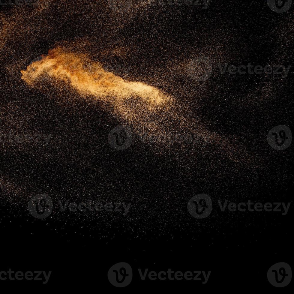 Sand explosion isolated on black background. Freeze motion of sandy dust splash.Sand texture concept. photo