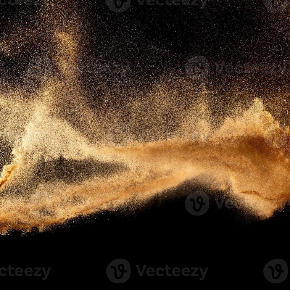 Sand explosion isolated on black background. Freeze motion of sandy dust splash.Sand texture concept. photo