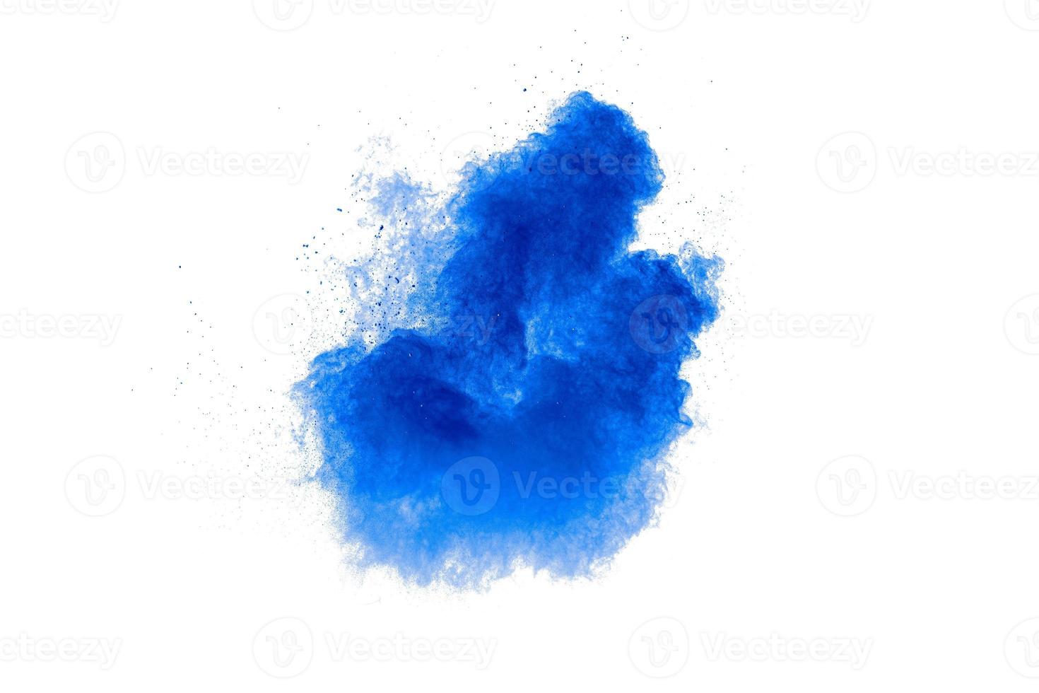 Blue color powder explosion cloud on white background.Blue dust particles splash. photo