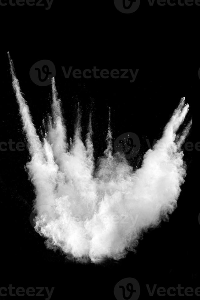 White powder explosion cloud against black background.White dust particles splash. photo