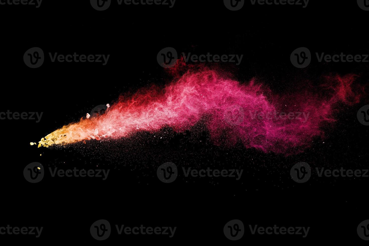 Split debris of stone exploding with red dust against black background. photo