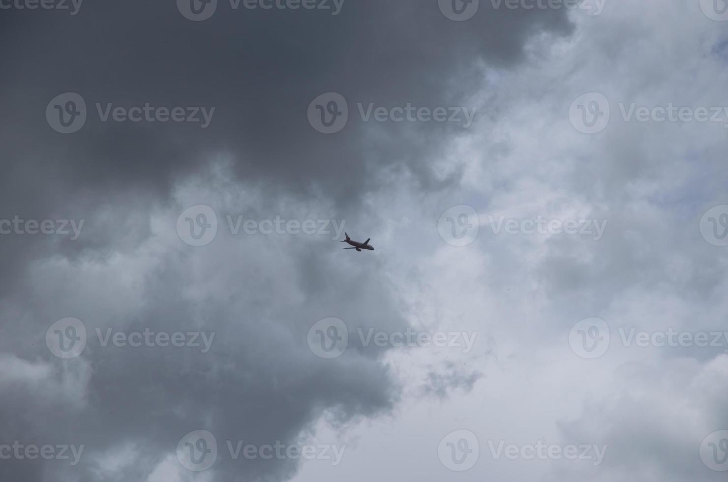 the sky with clouds and the silhouette of the plane in the sky, the background is natural photo