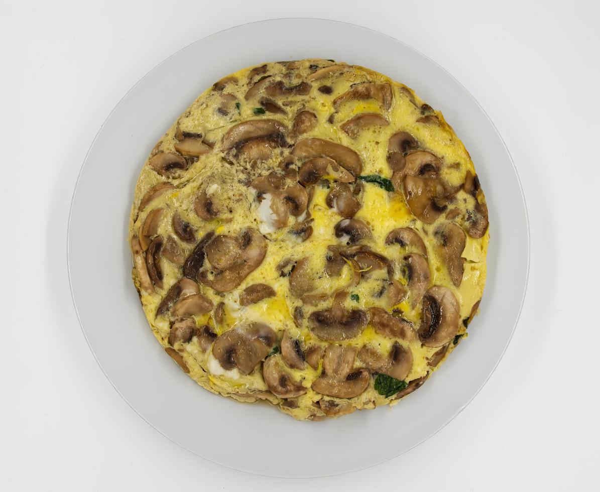 Omelette with mushrooms and cheese on white background. Top view. photo