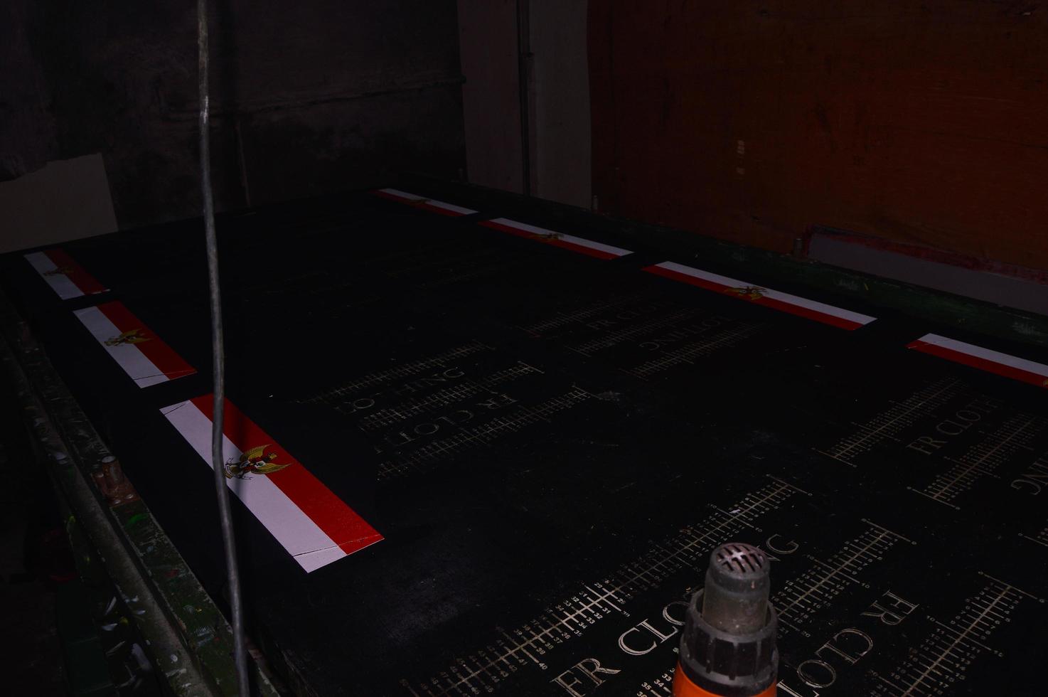 gresik, indonesia, 2022 - view of manual screen printing of the Garuda logo on a t-shirt photo