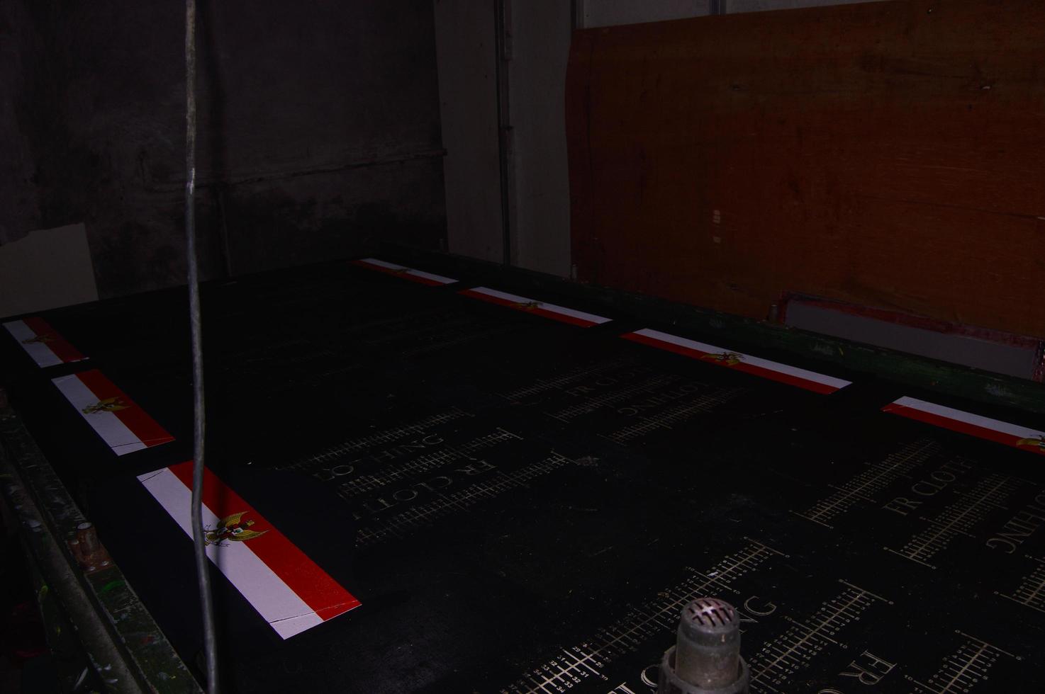 gresik, indonesia, 2022 - view of manual screen printing of the Garuda logo on a t-shirt photo