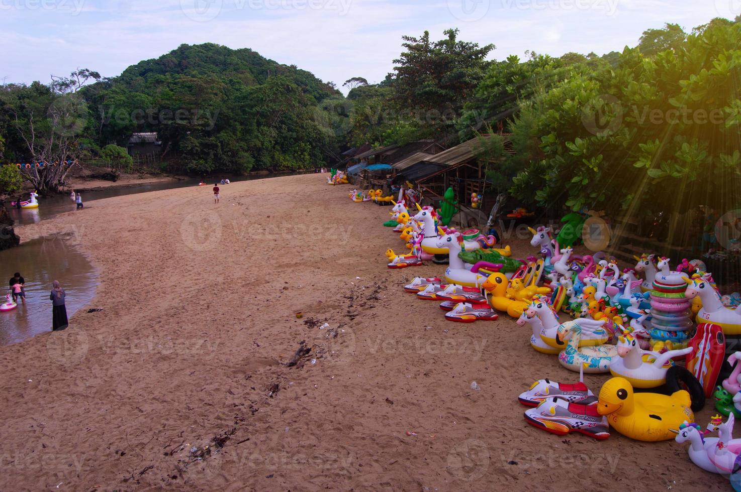 beachside view under the hills with float balloons lined up photo