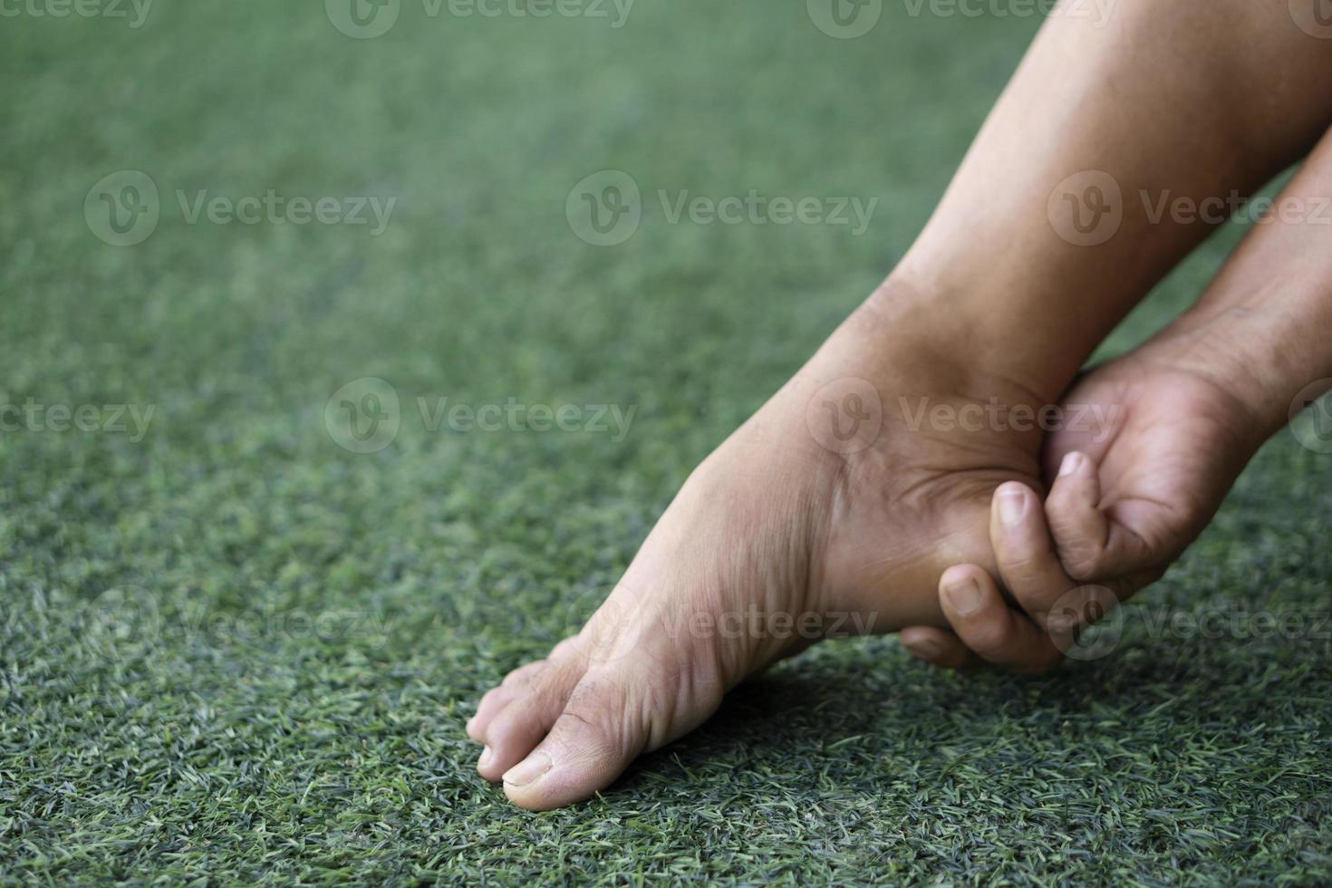 Closeup elderly hands massage her heel, foot  because of cramping  or sprain. Concept , health problems. Senior healthcare. Foot Massage for relieve of  hurt or painful. photo