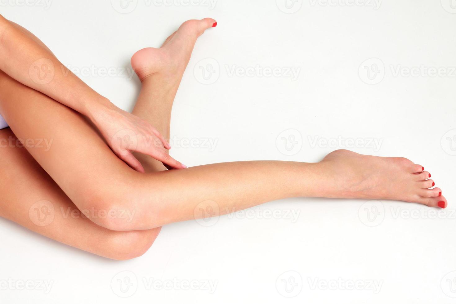 Beautiful long woman's legs with soft and clean skin. White background photo