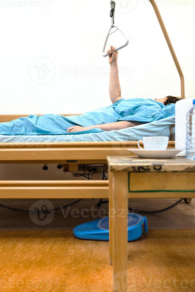 side view of hospital bed with sick person at home photo