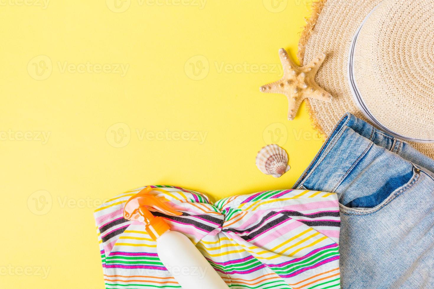 Woman summer outfit top view on blue yellow background. Fashion vacations concept photo