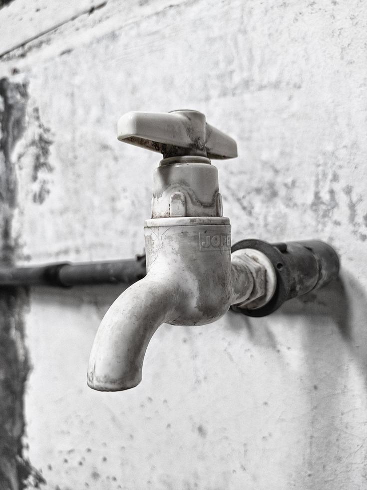 Water faucet details in black and white photography photo