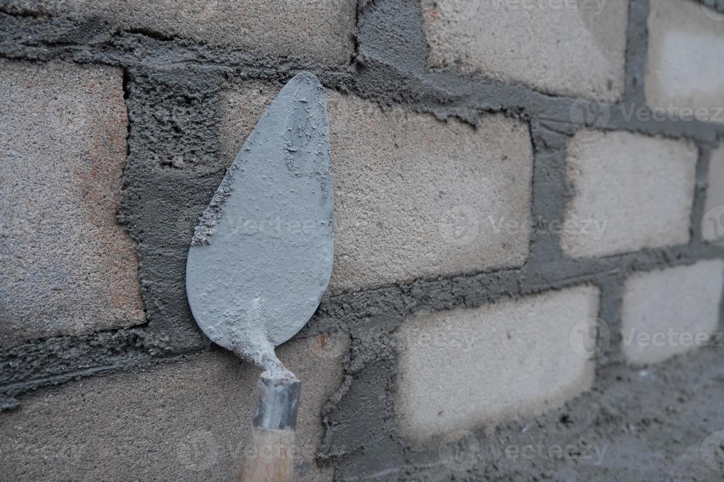 selectively focus on the dirty cement spoon because it is used to install bricks, in Indonesian the cement spoon is called cetok, soft focus photo
