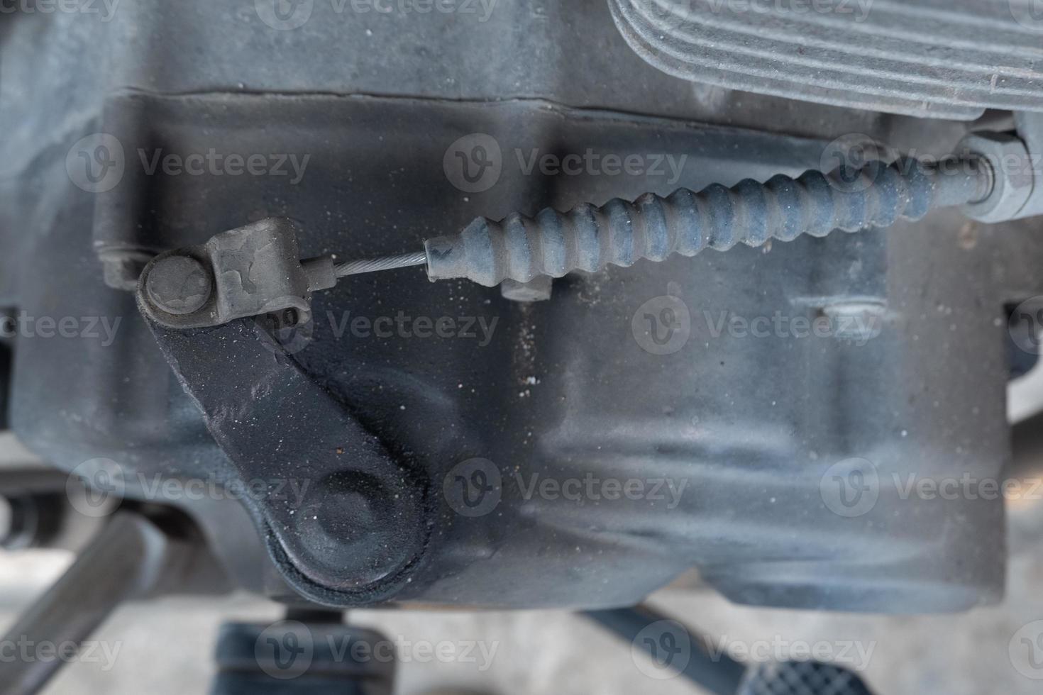 selective focus to old and dirty clutch sling of motorcycle engine, soft focus photo