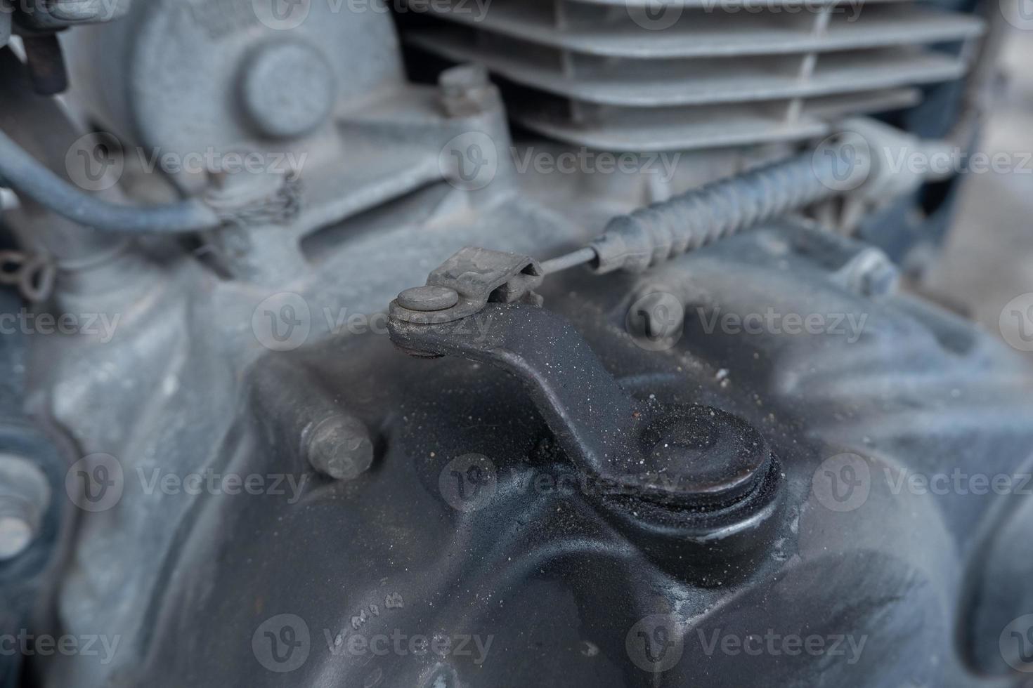 selective focus to old and dirty clutch sling of motorcycle engine, soft focus photo