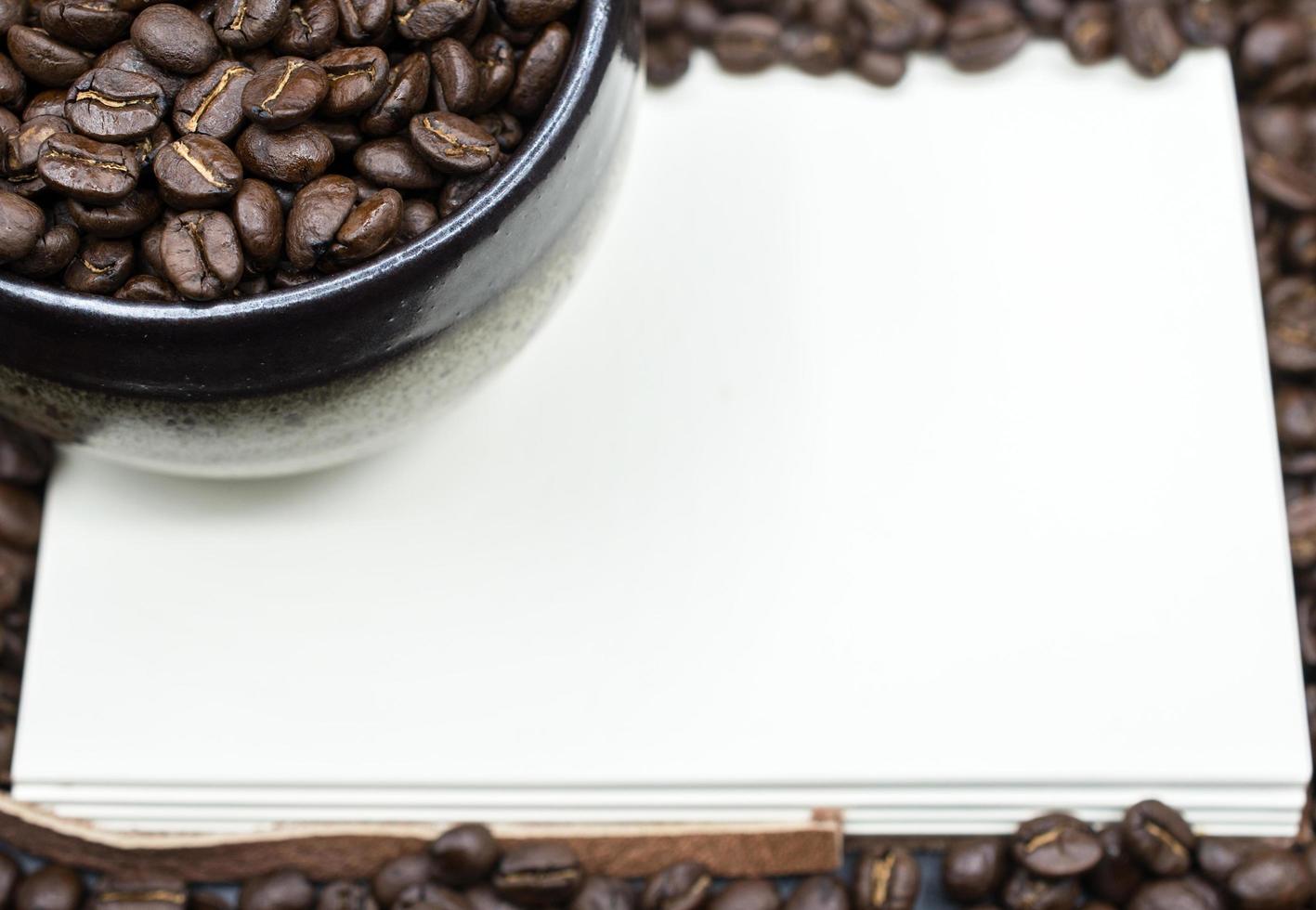 A book open the empty page with frame coffee beans background. photo