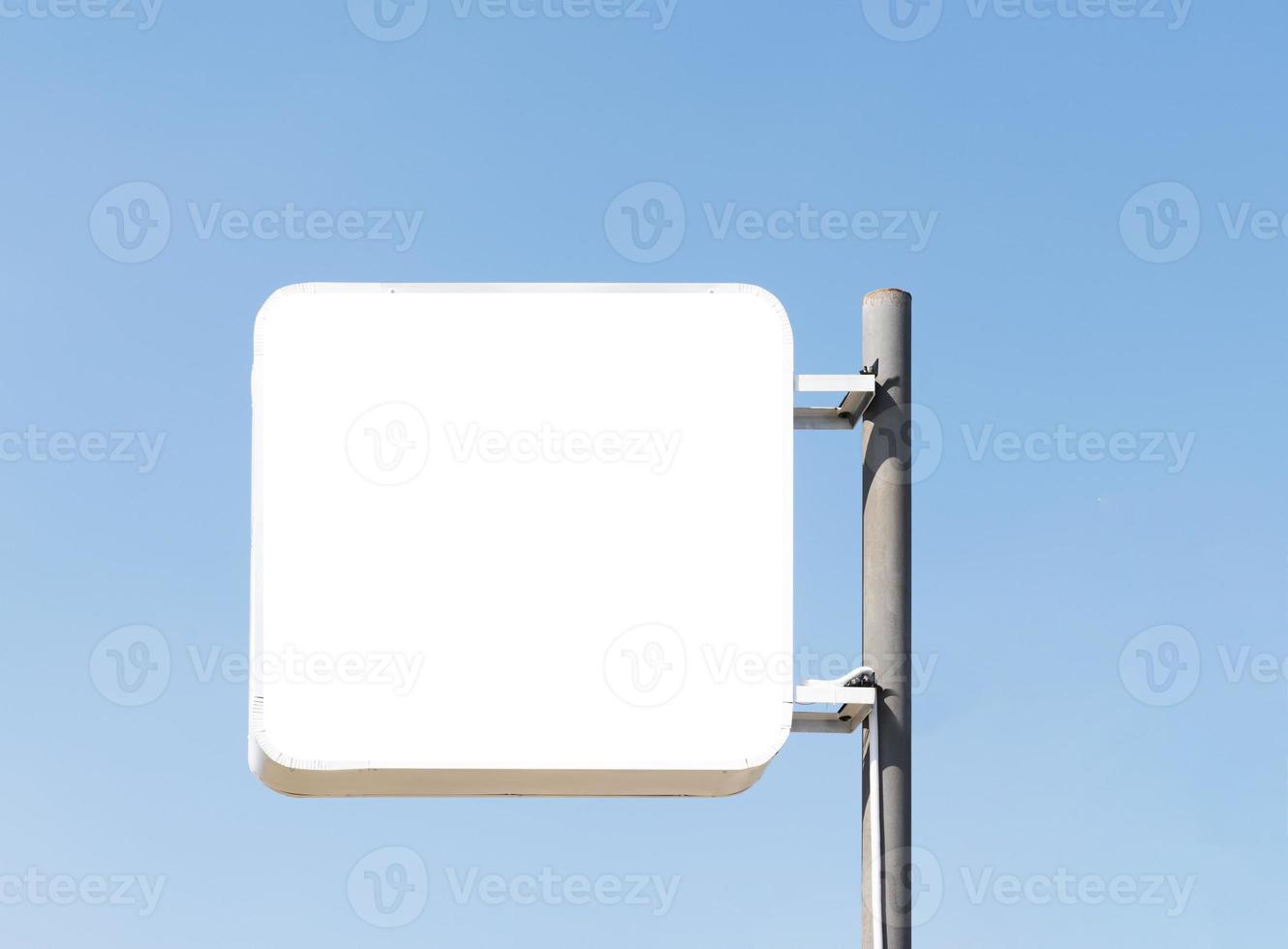 Outdoor pole billboard on blue sky background with mock up white screen and clipping path photo