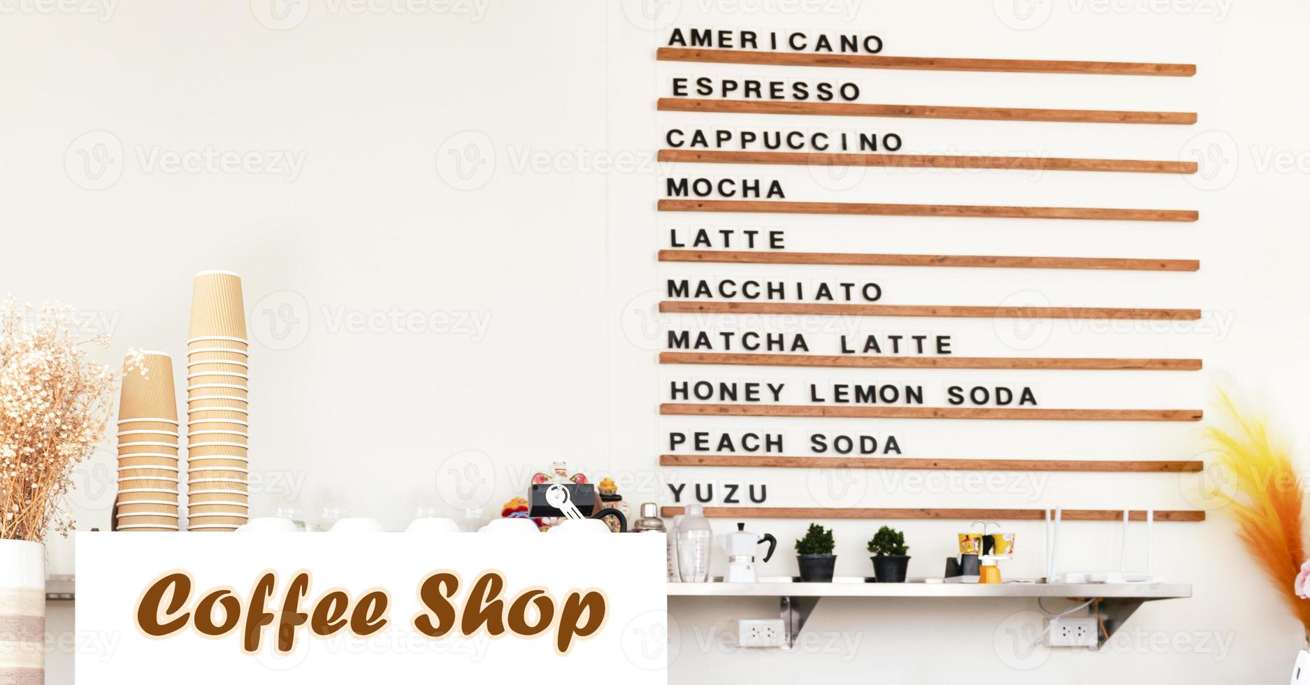 White coffee machine on counter with coffee menu on wooden shelf background in coffee shop photo