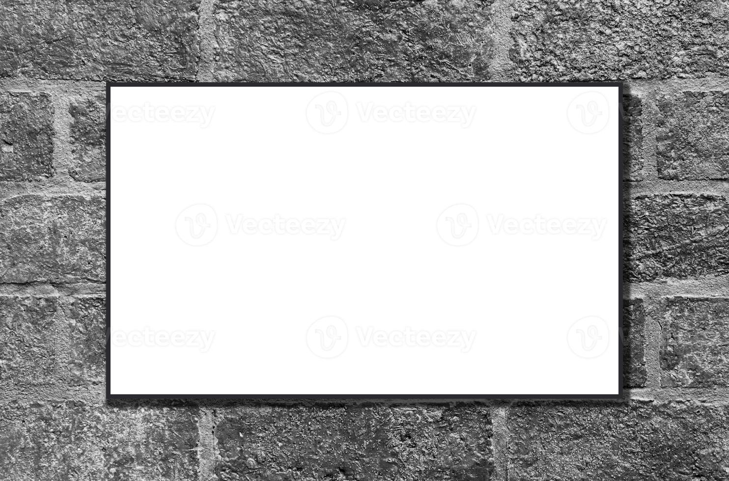 Mockup white picture frame on black brick wall background with clipping path photo