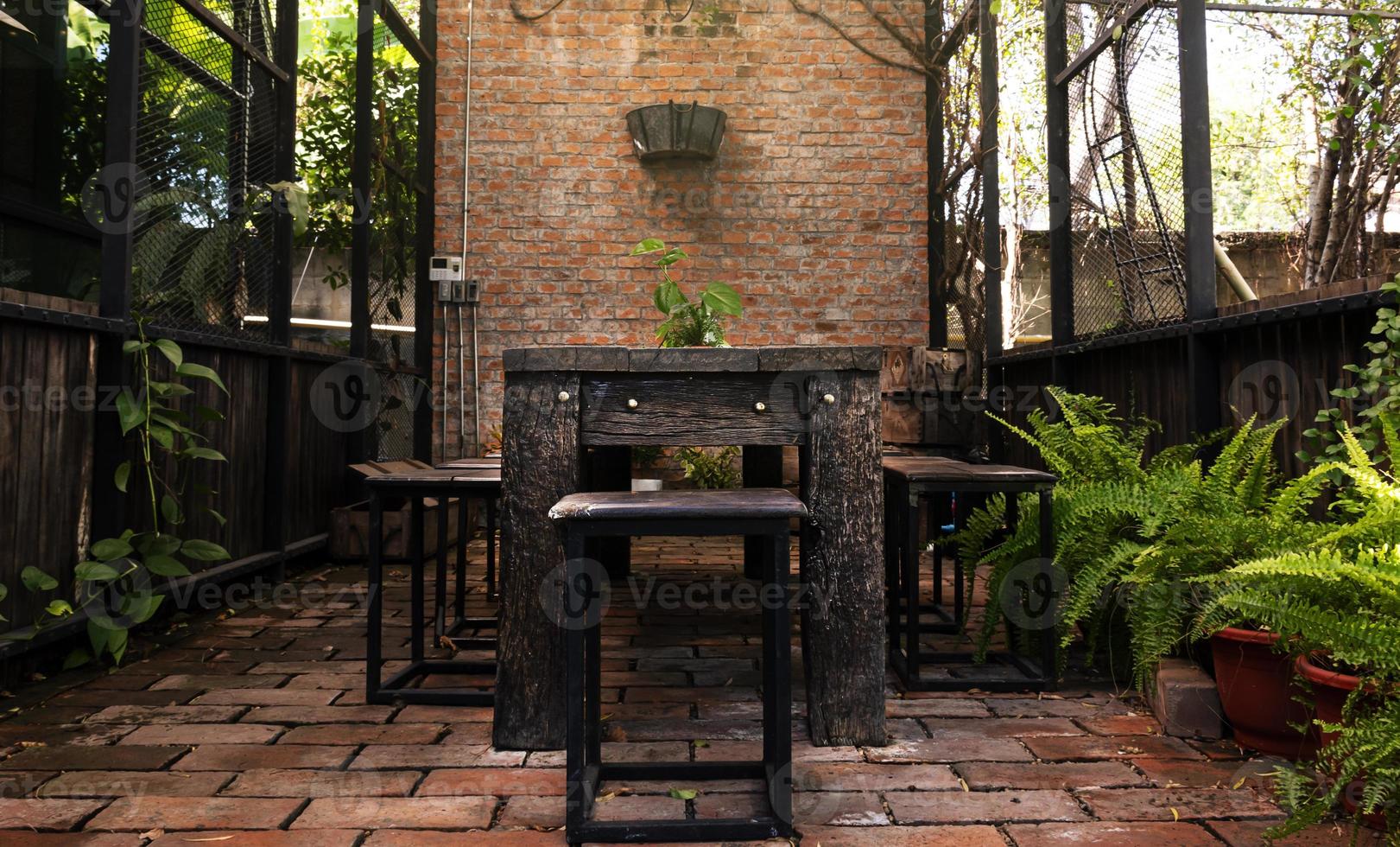 Outdoor retro wooden table and chair in garden photo