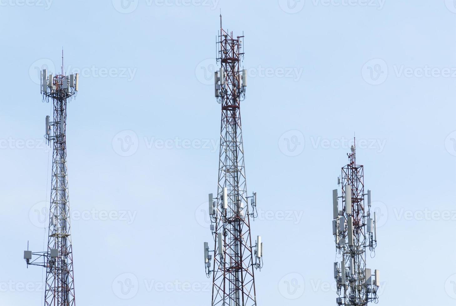 Three telecommunication tower on blue sky background photo