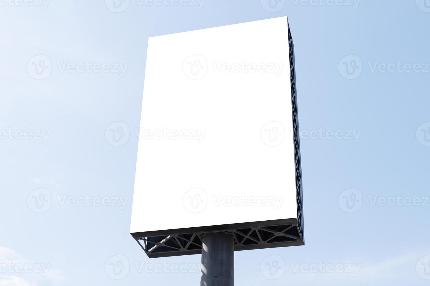 Outdoor pole billboard on blue sky background with mock up white screen and clipping path photo