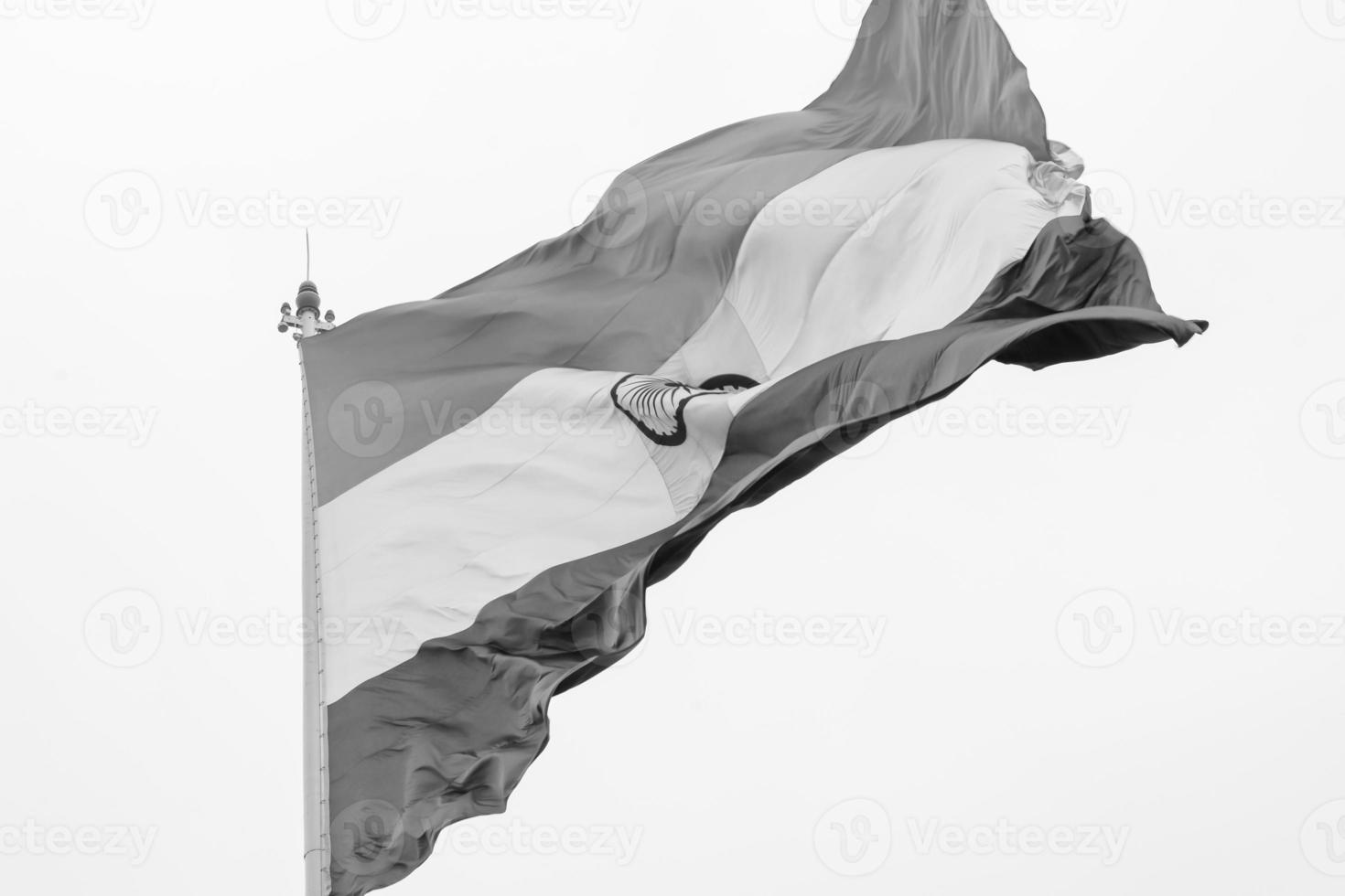 India flag flying high at Connaught Place with pride in blue sky, India flag fluttering, Indian Flag on Independence Day and Republic Day of India, tilt up shot, Waving Indian flag, Har Ghar Tiranga photo