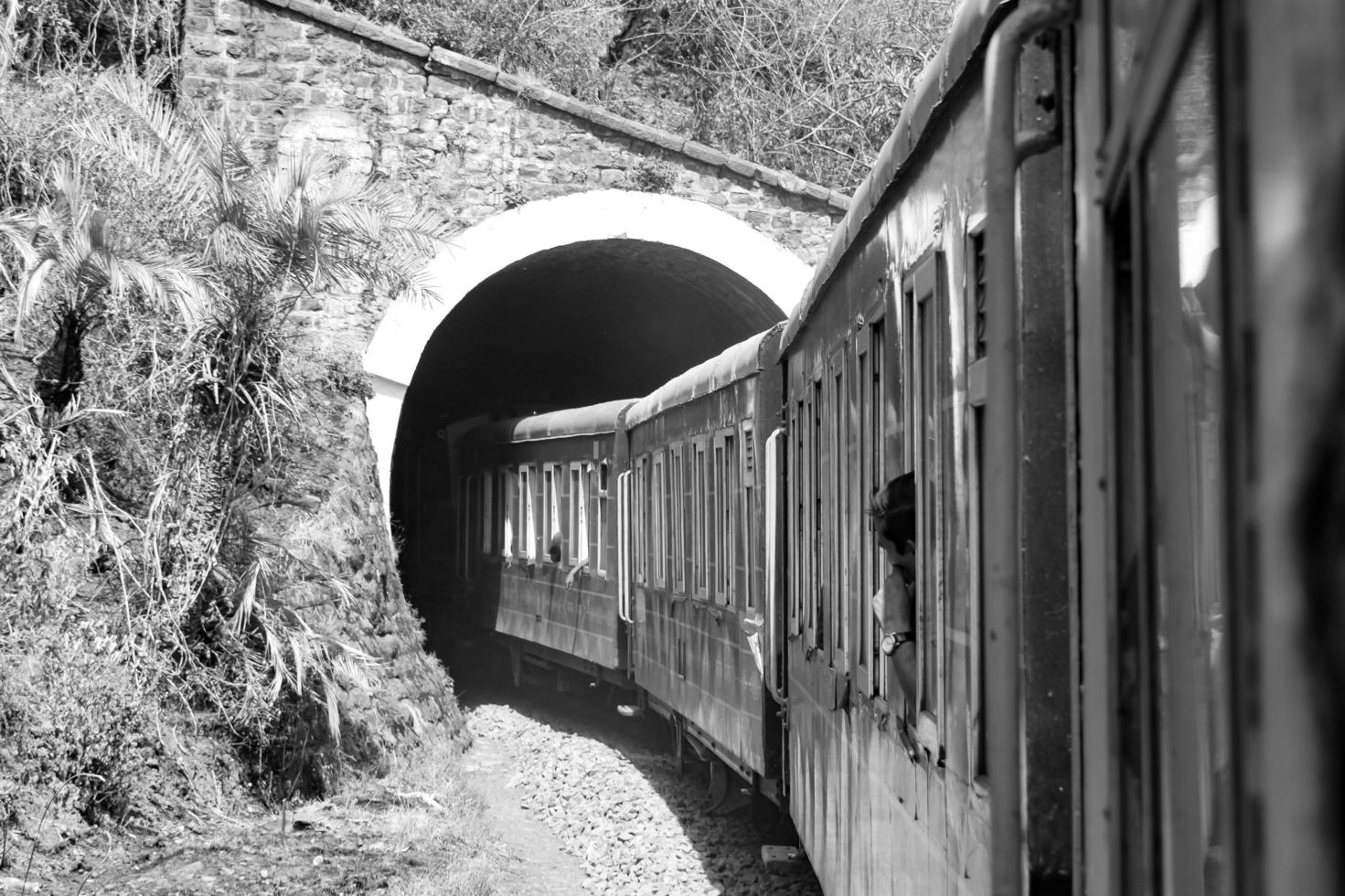 Shimla, Himachal Pradesh, India - May 14, 2022 - Toy train Kalka-Shimla route, moving on railway to the hill, Toy train from Kalka to Shimla in India among green natural forest photo