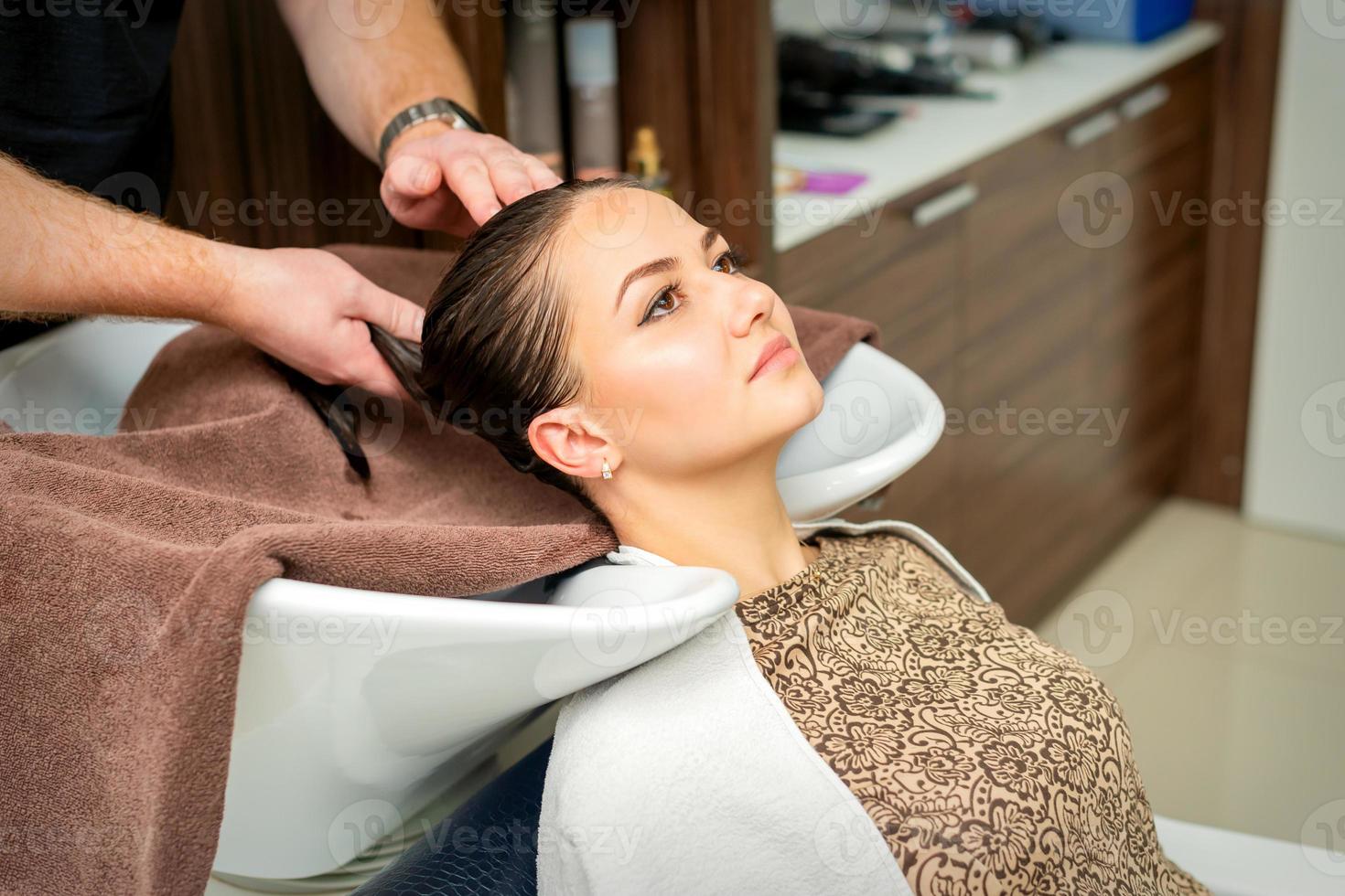 Hairdresser wipes the hair with towel photo