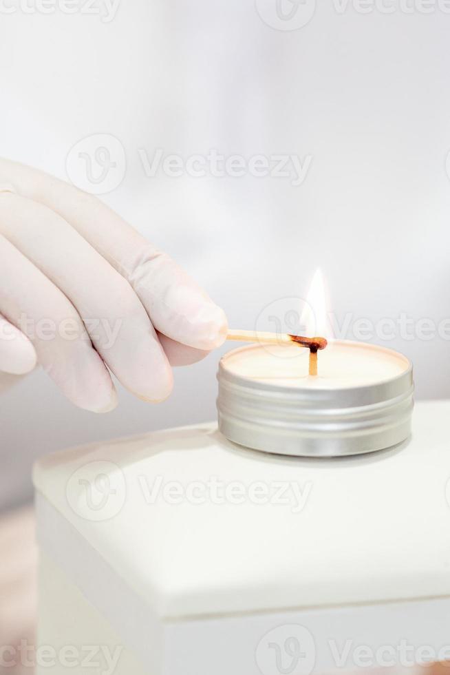 Manicure master is lighting candle photo