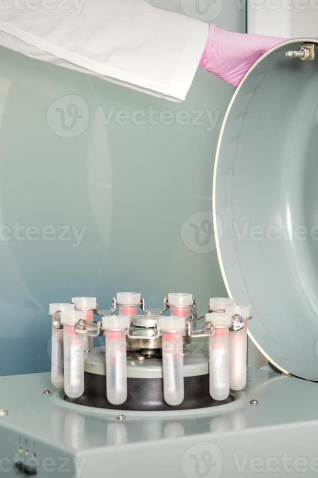 Centrifuge machine with blood test tubes photo