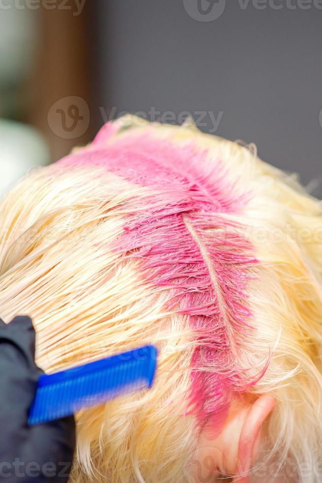 Hair coloring in pink color of woman photo