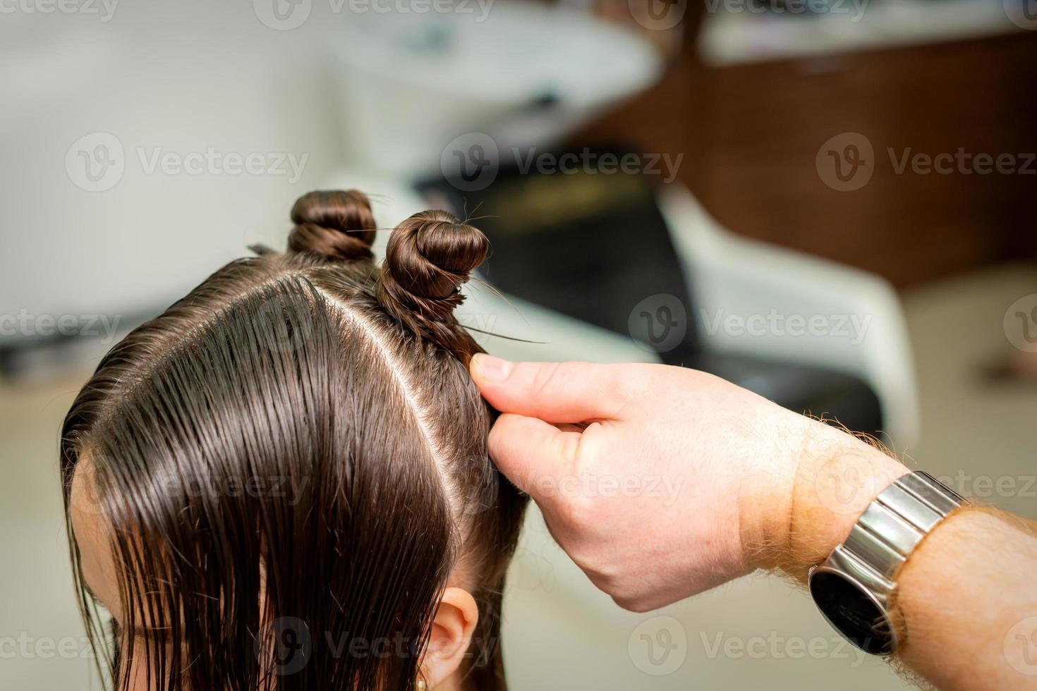 Young woman receives process of hairstyle photo