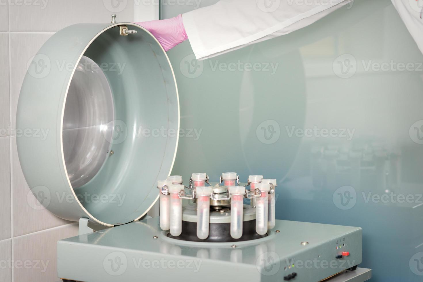 Centrifuge machine with blood test tubes photo