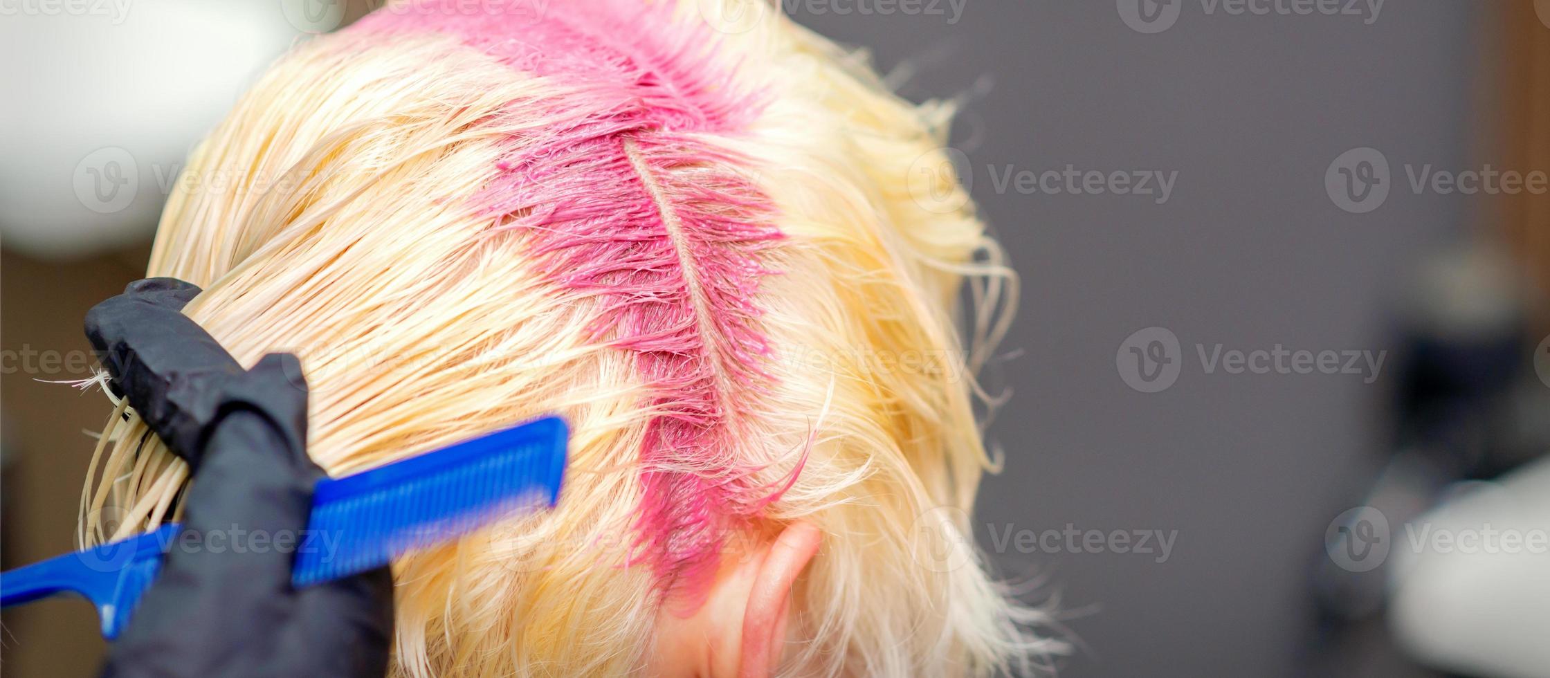 Hair coloring in pink color of woman photo