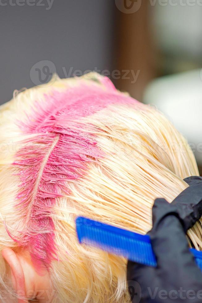 Hair coloring in pink color of woman photo