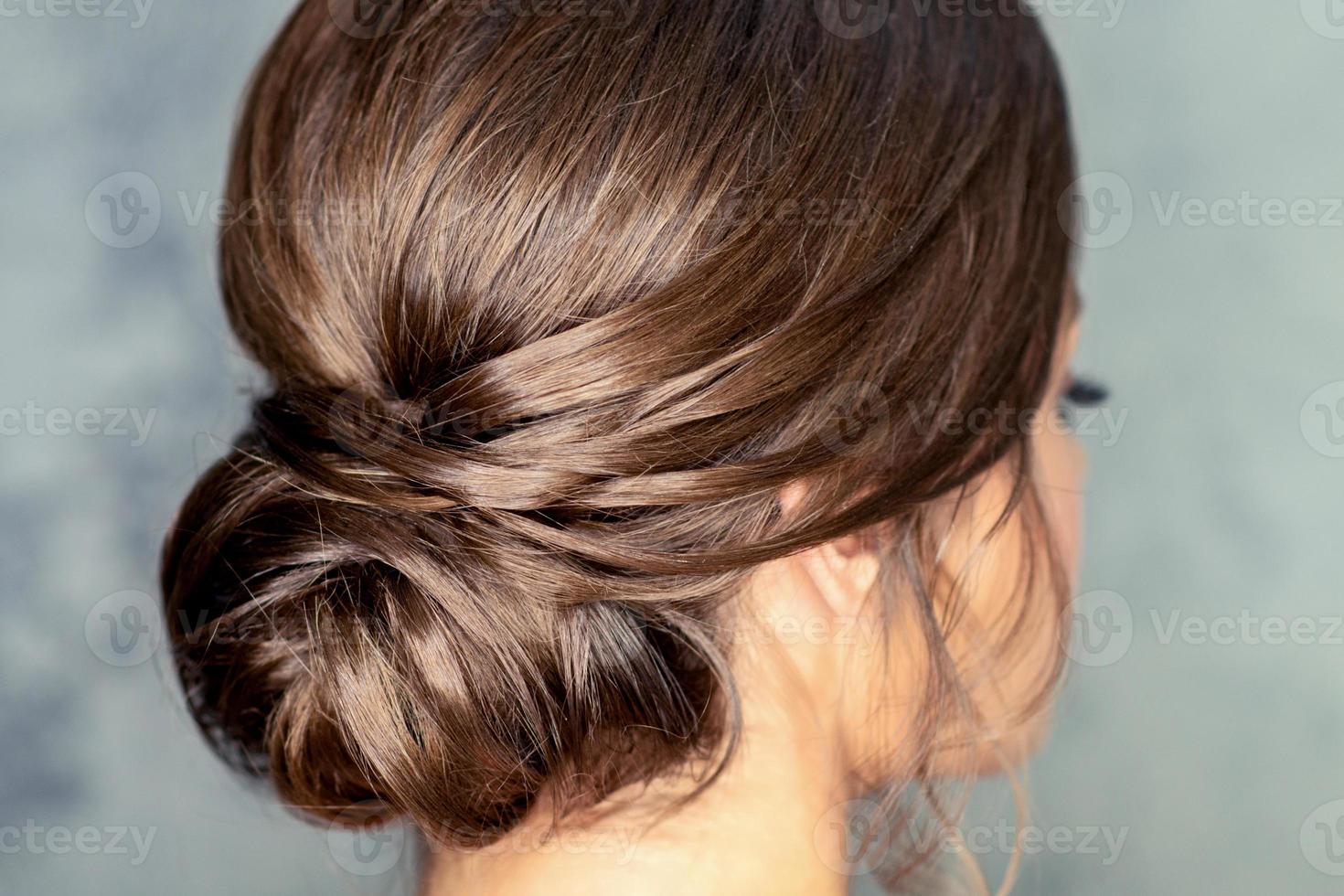 Brunette woman with middle bun hairstyle photo