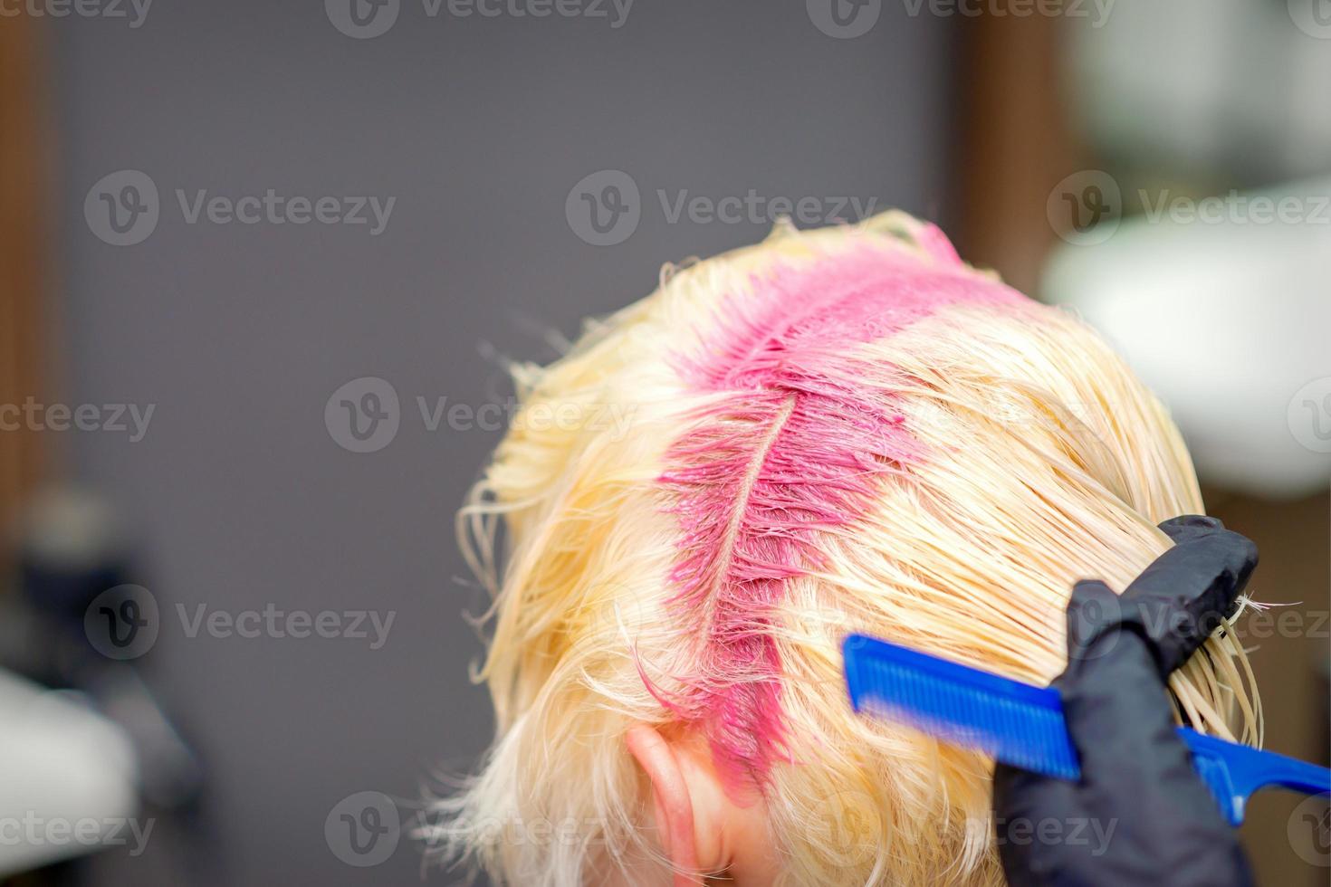 Hair coloring in pink color of woman photo