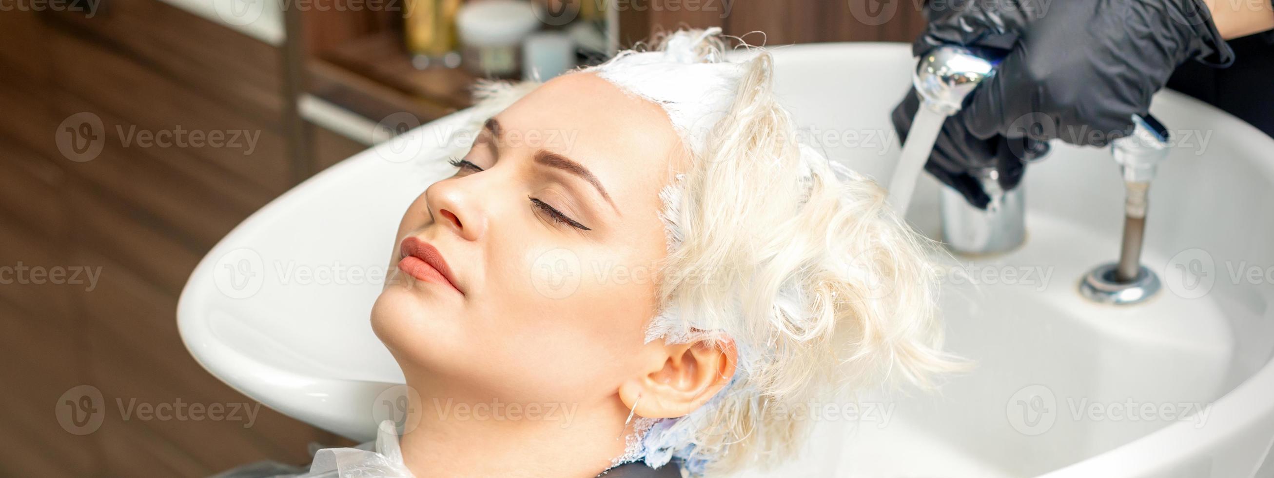 Hairdresser prepare to washes off the dye photo