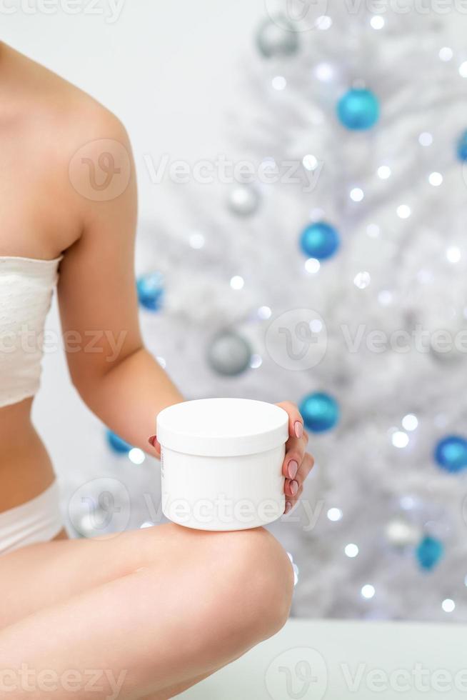 White plastic jar in hand of woman photo