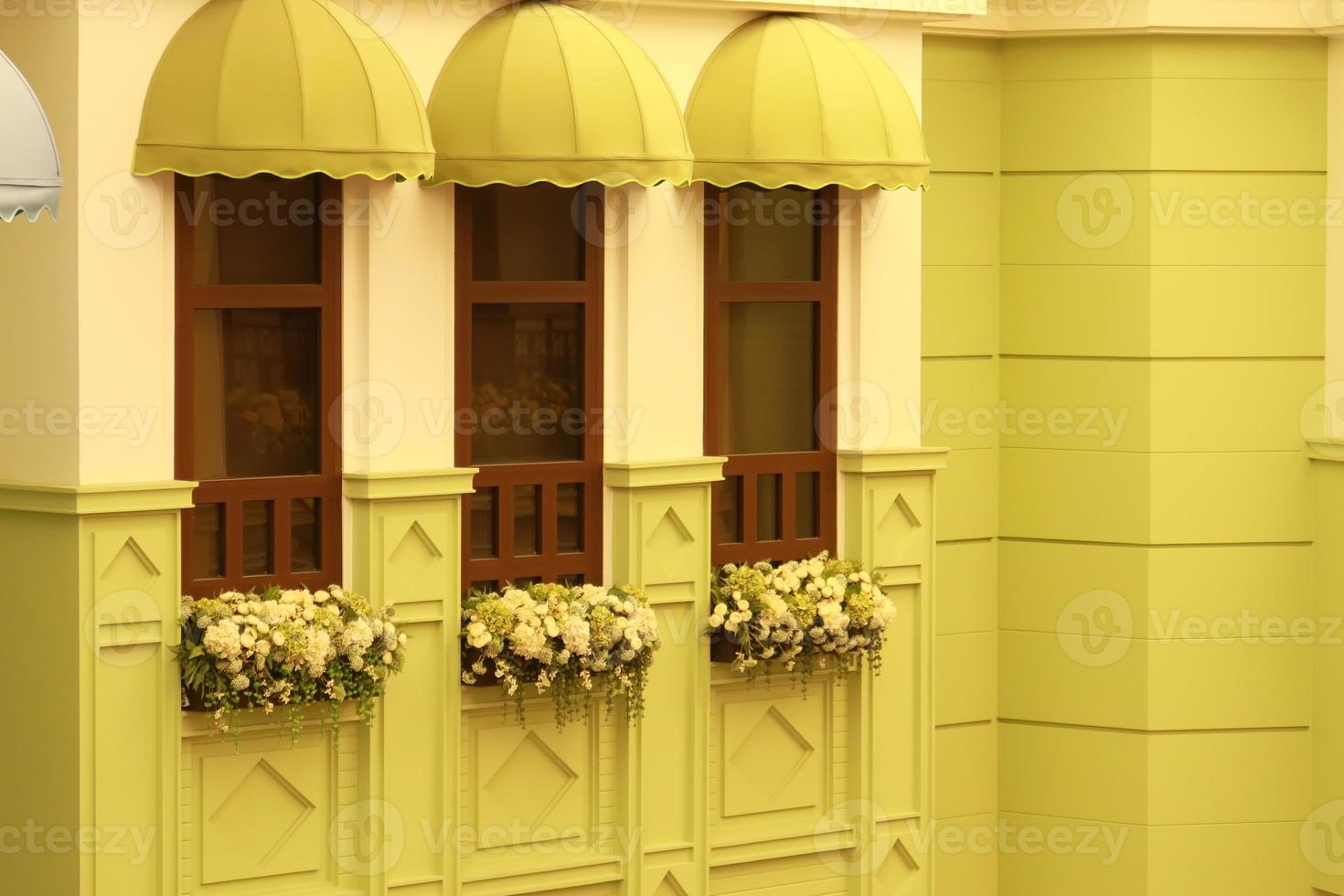 detail shot of vintage yellow color windows on a buildings photo