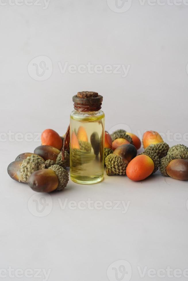 Acorn essential oil isolated on white background. photo