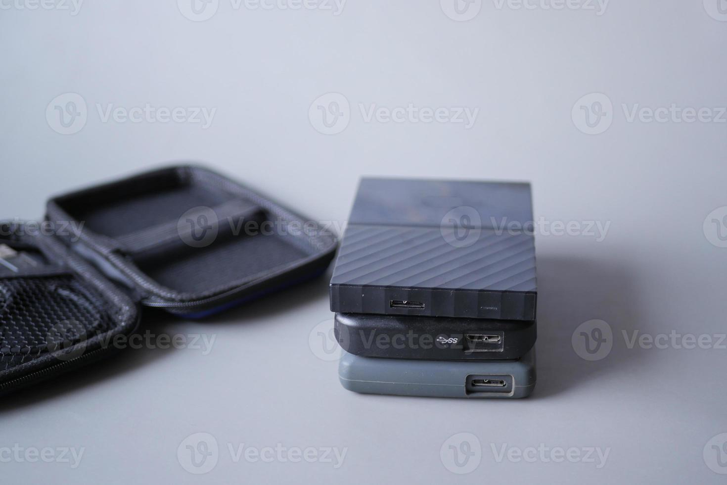 stack of external hard drives on table photo