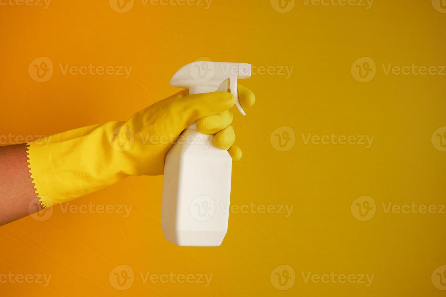 holding a plastic bottle spraying disinfect photo