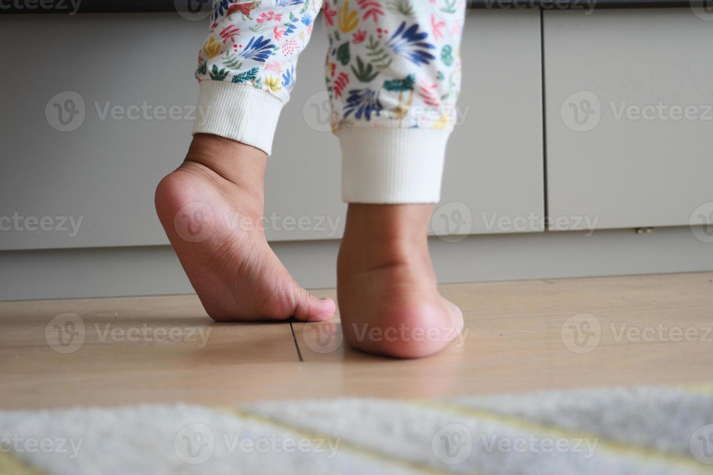 low angle view of A child walking on tiptoes photo