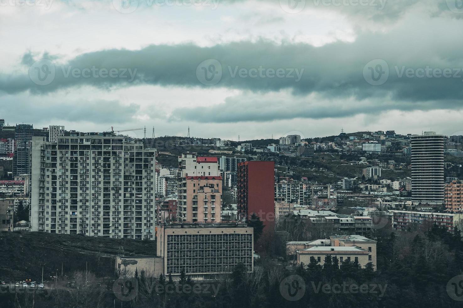 Dark stormy cloudscape over the city. Urban landscape with stormy sky. photo